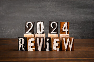 2024 Review. Alphabet blocks on wooden texture table - 794351561