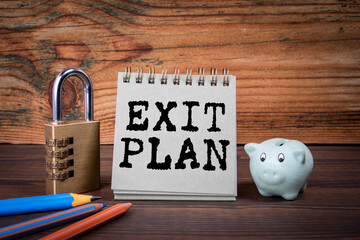 Exit Plan. Cardboard notepad on wooden texture table