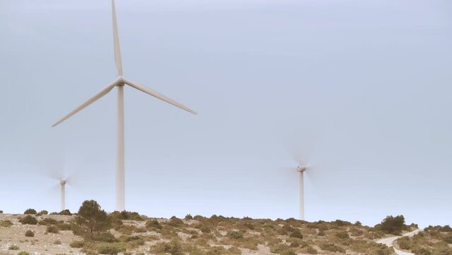Time lapse. Wind turbines, power generator farm, France. Generating green ecological power energy. Windmills on eco field.