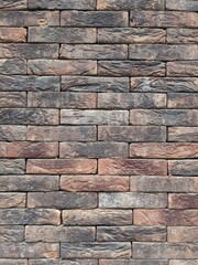 Close up of a colorful and textured brick wall - 794364916