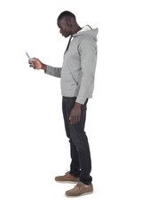 side view of a man holding a smartphone on white background