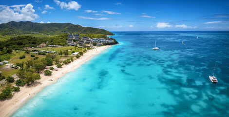 Aerial view of the beautiful Ffryes Beach at the Caribbean island of Antigua with turquoise sea and fine sand