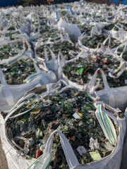 crushed glass in bags ready for recycling