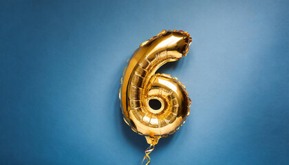 Banner with number 6 golden balloon. Six years anniversary celebration. Bright blue background.