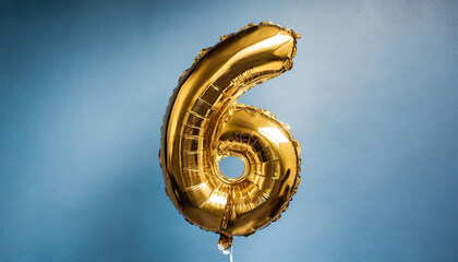 Banner with number 6 golden balloon. Six years anniversary celebration. Bright blue background.