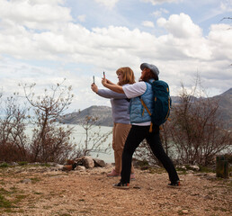 senior friends tourists outdoor adventure together on mediterranian sea