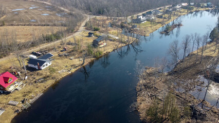 Am aerial view of a lake and cottages. 