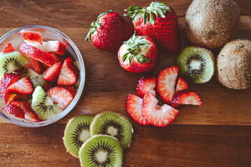 Strawberries and kiwis being prepared for a snack