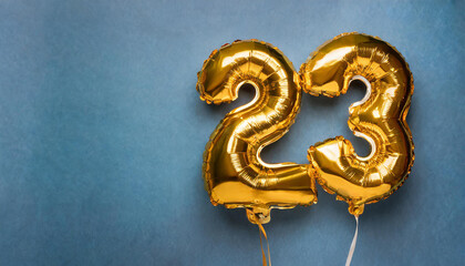Banner with number 23 golden balloon. Twenty three years anniversary celebration. Blue background.