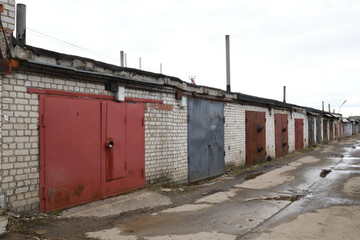 Brick garages with metal gates of garage cooperative in Russia