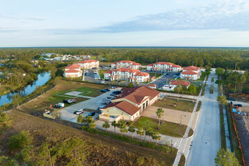 Aerial view of american apartment buildings in Florida residential area. New family condos as...