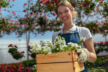 Woman with wooden crate full of blooms