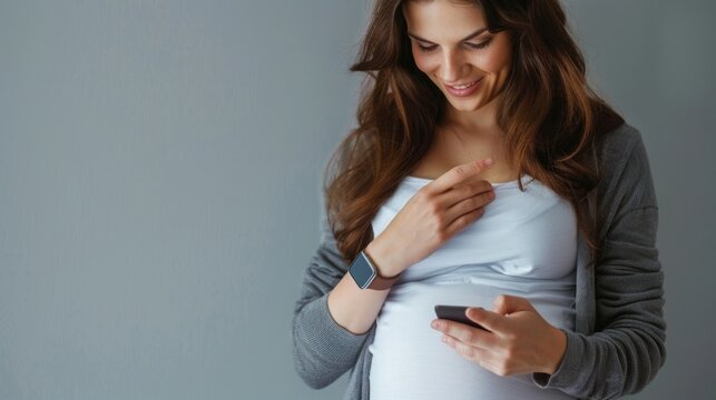 Pregnant Woman Looking at Cell Phone