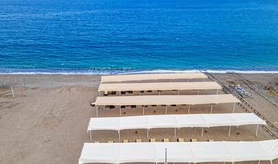 Aerial  view of the beach with sunbeds and umbrella at Kemer, Antalya by drone