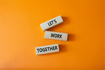 Lets work together symbol. Concept words Less is More on wooden blocks. Beautiful orange...