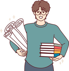 Man student with textbooks and papers for creating engineering drawings, smiles and looks at screen. Guy student studying at university or college holds books recommended by teacher