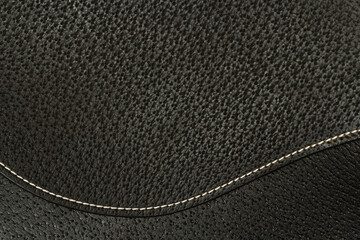 Leather texture with stitches. Closeup image of dark brown horse saddle fragment. 