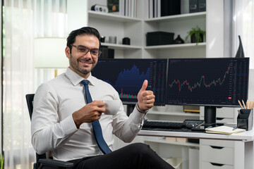 Naklejka na ściany i meble Profile of successful in trader businessman looking at camera with two stock exchange investment screens with raising fist up and thumb up in dynamic financial technology graph stock market. Surmise.
