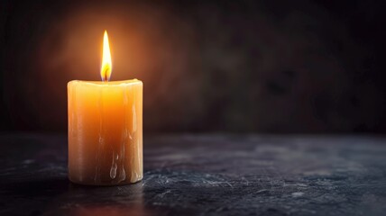Lit wax candle with bright flame and dripping on dark background