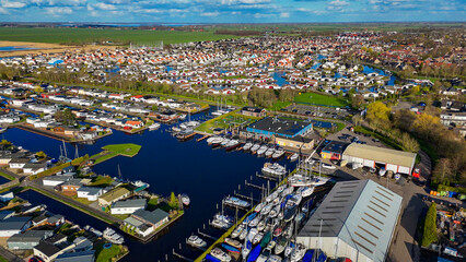 Obraz premium Aerial drone view geometric pattern of water houses, marina, yachts Marina Park Lemmer Netherlands