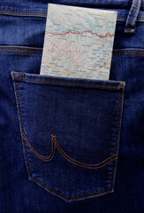 blurred toustic paper map In Back of blue jeans Pocket. rear view.