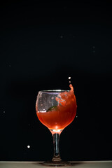 Splashes in a glass cup with guava juice inside.