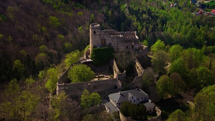 Medieval Chojnik Castle atop Karkonosze mountain in aerial shot.