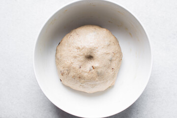 hot cross bun dough proofing in a white mixing bowl, bread dough resting in a ceramic bowl, process...