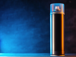 Aerosol enclosed can with paint or varnish on a blue background, copy space