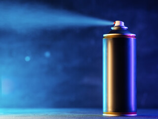 Spray an aerosol can . Blue background
