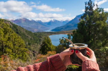 Woman's hands holding a delicious Argentine Mate during her summer vacation in Bariloche, Argentina.