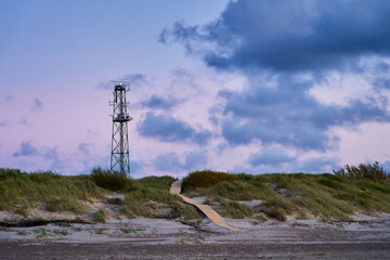 A coastal patrol tower stands on the border of the sea. A border guard tower with cameras guards...