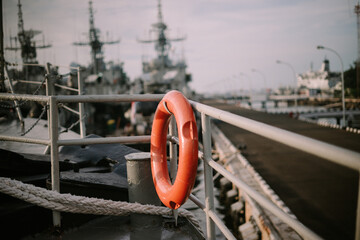 Orange lifebuoys placed on a ship, serving as vital safety equipment for emergencies at sea,...