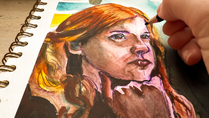 Close-up view of watercolor portrait. POV drawing details of girls face using color pencil on aquarelle. Watercolour painting in sketchbook. Film grain texture. Soft focus. Blur