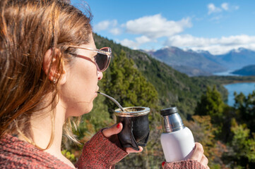Woman enjoying a delicious Argentine mate during her summer vacation in Patagonia, Argentina.