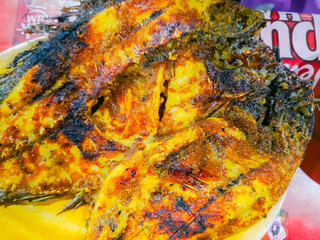 Grilled fish ready to be eaten, showcasing a delicious and flavorful seafood dish, perfect for enjoying a meal with family or friends