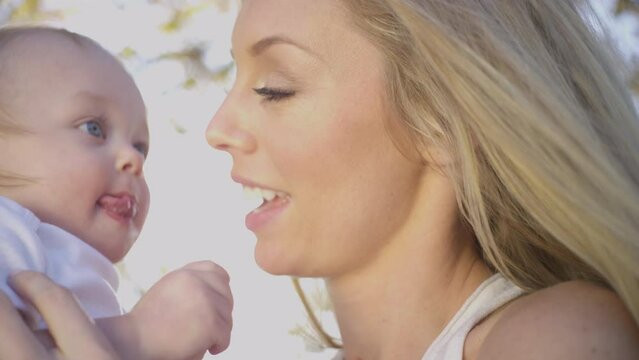 Beautiful Blonde mom and cute baby boy family fun outdoor