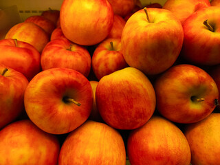 Apples showcased in a fruit shop display, presenting their crisp texture and vibrant colors,...