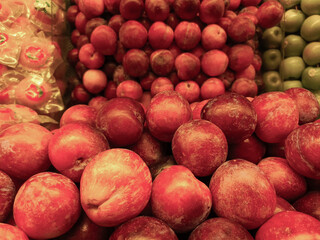 Apples showcased in a fruit shop display, presenting their crisp texture and vibrant colors, inviting customers with their freshness and appeal