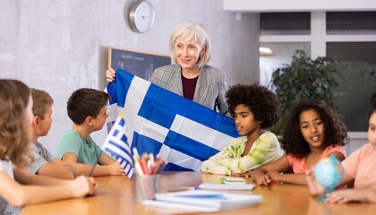 curious students listen attentively to the teacher who tells interesting facts about Greece