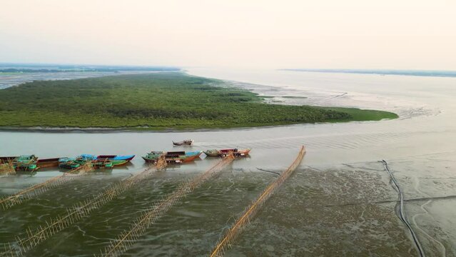 Aerial view of drazer machine and troller boat in the river with seaside mangroves 