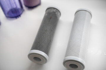 New and used carbon filter for reverse osmosis purification water system on the table in the...