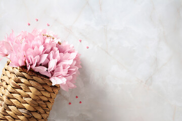 Woven rattan flower basket on stone background. Happy Mother's Day, International Women's Day, Birthday concept.