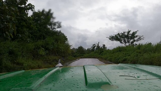 driving range rover on a hilly road with rain 