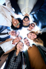 Vertical low angle view of cheerful group of diverse business people in formal wear are gathered in...