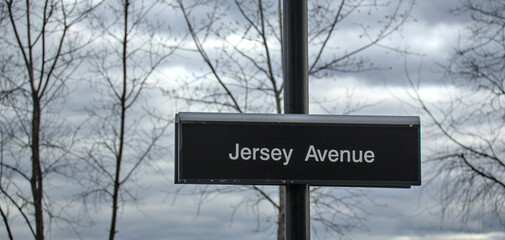 Jersey Avenue light rail sign on commuter train platfrom in Jersey City, New Jersey.