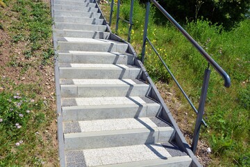 Pavement and terrace slabs , concrete with grit stairs with handrail leading to the top