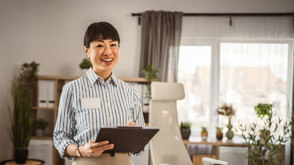 Portrait of japanese mature woman hold clipboard at office