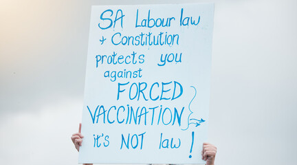 Hands, poster and protest for vaccine, covid and opinion with sign, medical and human rights in...