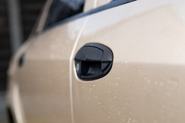 A handle in a car door.